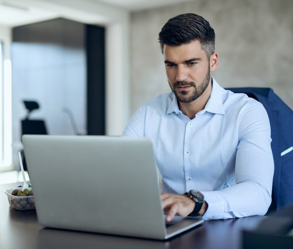 Male entrepreneur using computer while working in the office.