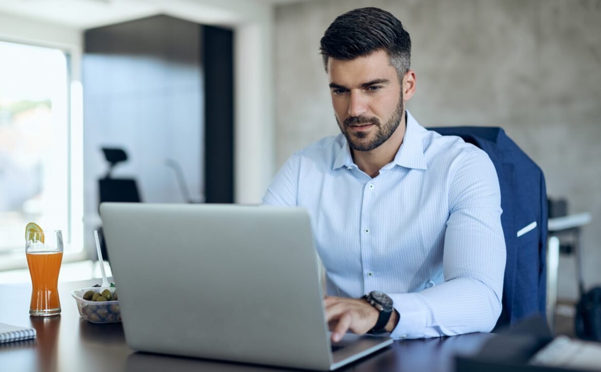 Male entrepreneur using computer while working in the office.